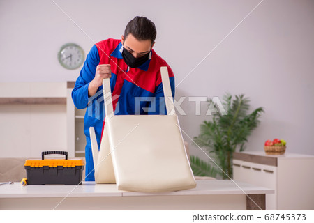 Young carpenter working indoors during pandemic disease 68745373