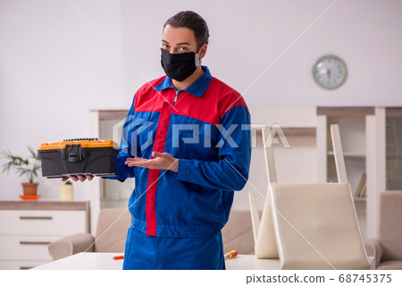 Young carpenter working indoors during pandemic disease 68745375