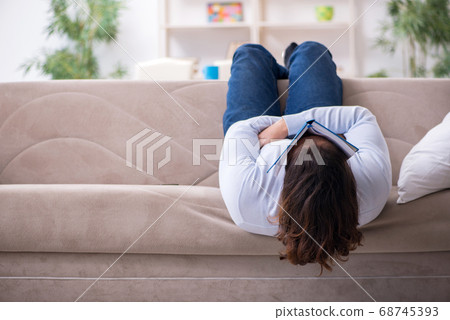 Young male student preparing for exams at home 68745393