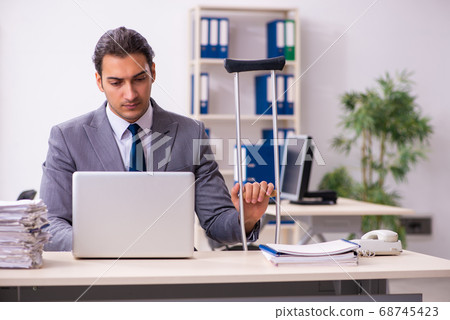 Leg injured employee in the office Leg injured employee in the office 68745423
