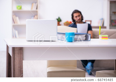 Young man employee working from house Young man employee working from house 68745485