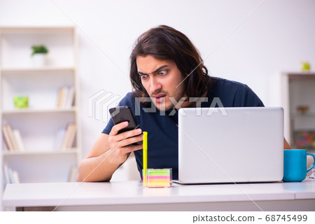 Young man employee working from house 68745499