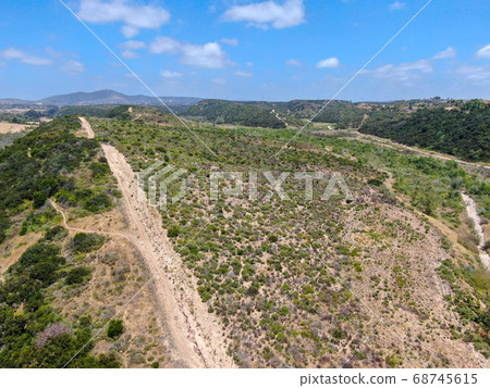 Aerial view of of small dry rocky trails in the mountain. Aerial view of of small dry rocky trails in the mountain. 68745615