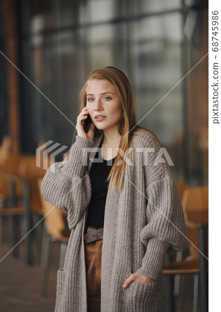 Young Woman with Mobile in Cafe. Brunette Female Waving Hand. Coffe and Croissants. Man and Smiling Girl. Brunette Woman. Rest Concept. Caffee House. Smiling Girl with Cup. Attractive 68745986