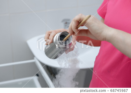 Face cryomassage, adult woman. Cosmetologist using liquid nitrogen. The science of rejuvenation. 68745987