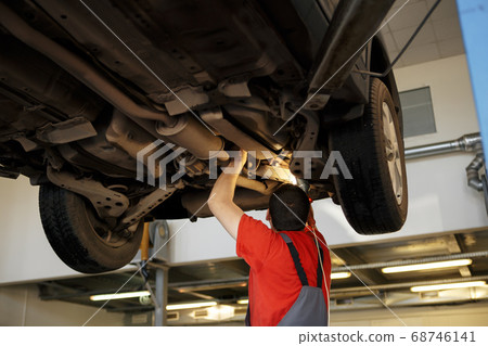 Portrait of a mechanic at work in his garage 68746141