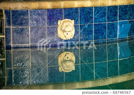 A Shot of a Pool Fountain Reflecting off the Water 68746567