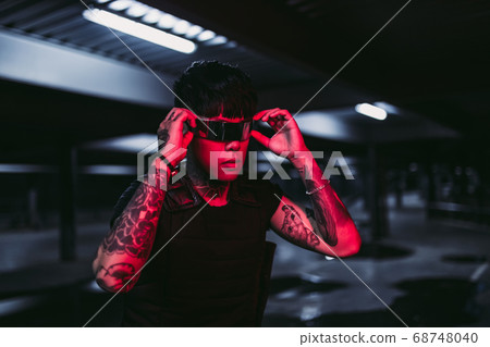 Man in the night city. Portrait of a man with Asian appearance in a neon city. 68748040
