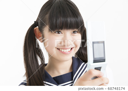 Junior high school girl looking at mobile mail 68748174