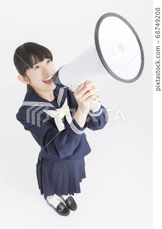 Female junior high school student shouting with a loudspeaker Female junior high school student shouting with a loudspeaker 68749208