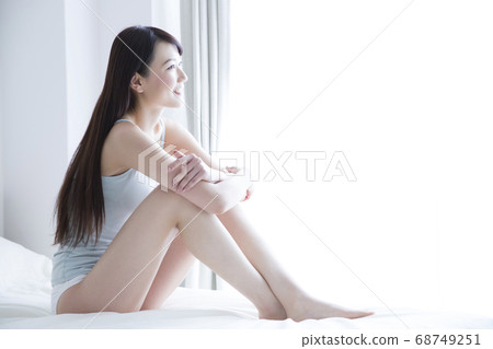 Woman relaxing in bed Woman relaxing in bed 68749251