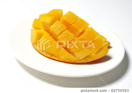 Mango of diced tropical fruits on a plate 68750563