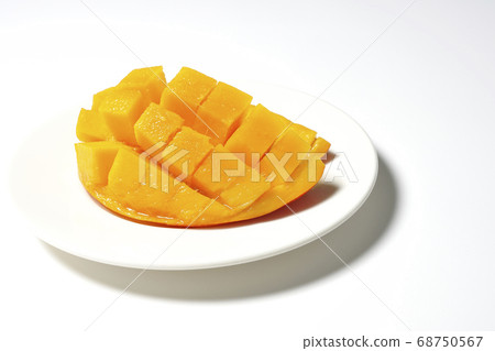 Mango of diced tropical fruits on a plate 68750567