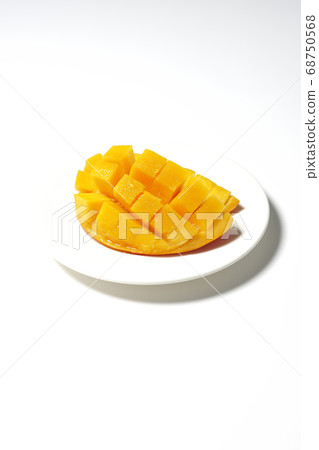 Mango of diced tropical fruits on a plate 68750568