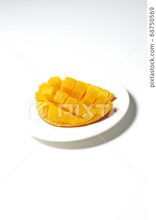 Mango of diced tropical fruits on a plate 68750569