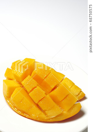 Mango of diced tropical fruits on a plate 68750575