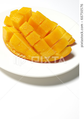 Mango of diced tropical fruits on a plate 68750576