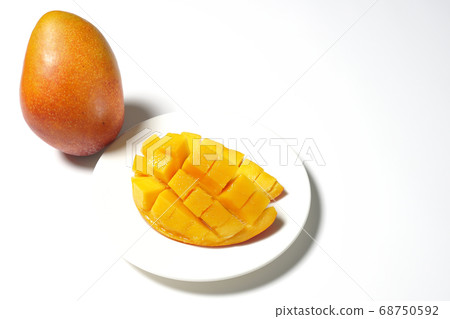 Mango of diced tropical fruits on a plate 68750592