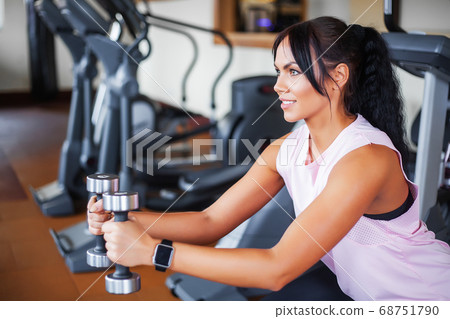 Fitness woman. Young attractive woman doing exercises in fitness gym. 68751790