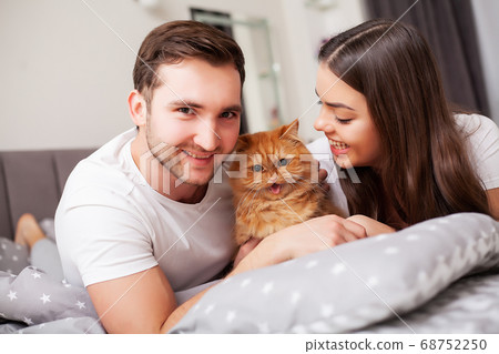 Happy couple having fun in bed. Intimate sensual young couple in bedroom enjoying each other Happy couple having fun in bed. Intimate sensual young couple in bedroom enjoying each other 68752250