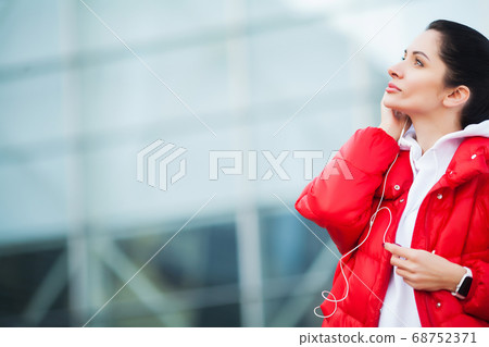 Fitness woman doing workout standing in a stadium background Fitness woman doing workout standing in a stadium background 68752371