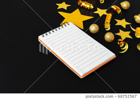 Blank sheet of paper with golden decorative stars. New year resolutions concept Blank sheet of paper with golden decorative stars. New year resolutions concept 68752567