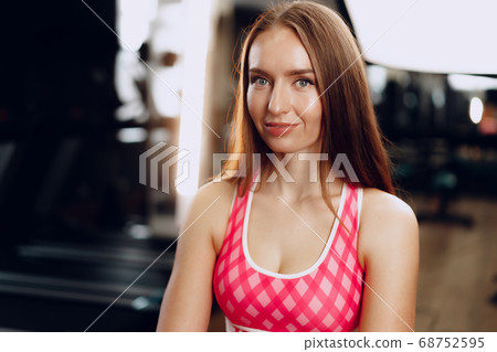 Young beautiful woman in sportswear in a gym 68752595