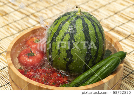 Watermelon and summer vegetables to cool in a tub Watermelon and summer vegetables to cool in a tub 68752850