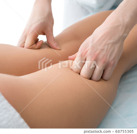Cropped view of a woman being massaged in spa Cropped view of a woman being massaged in spa 68755305