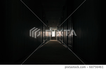 gloomy dark corridor with closed doors of an empty hotel without people during quarantine 68756461