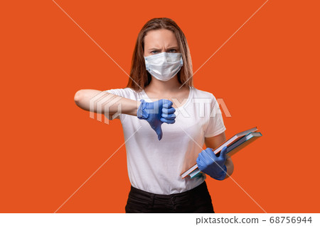 quarantine restriction pandemic protest thumb down 68756944