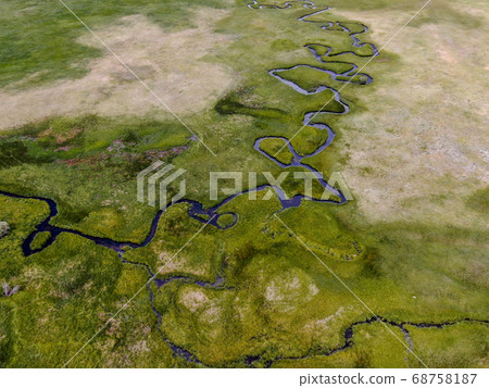 Aerial view of green land and small curve river in Aspen Springs 68758187