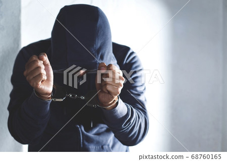 Hand of the prisoner on a steel lattice 68760165