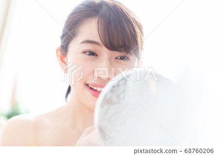 A woman applying a lip 68760206