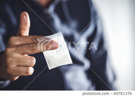 Junkie man holding drug syringe injection heroin 68761376