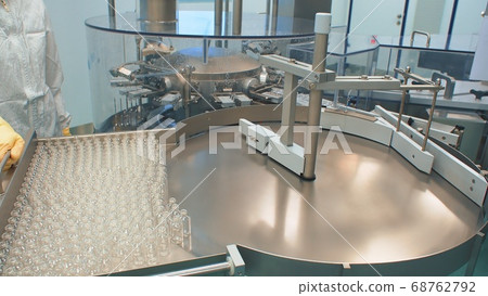 coronavirus. Pharmaceutical optical inspection machine for ampoules, medical vials and vials. Manufacturing of the vaccine coronavirus. Pharmaceutical optical inspection machine for ampoules, medical vials and vials. Manufacturing of the vaccine 68762792