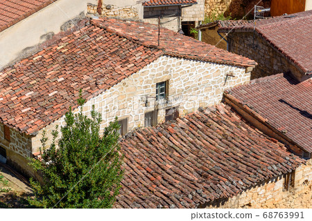 Background of old village houses with stone walls and red tile roofs 68763991