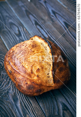 Homemade tartine bread on dark wooden table 68764070