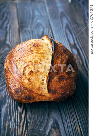 Homemade tartine bread on dark wooden table Homemade tartine bread on dark wooden table 68764071