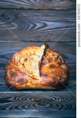 Homemade tartine bread on dark wooden table Homemade tartine bread on dark wooden table 68764072