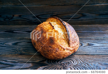 Homemade tartine bread on dark wooden table Homemade tartine bread on dark wooden table 68764080