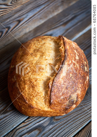 Homemade tartine bread on dark wooden table 68764085