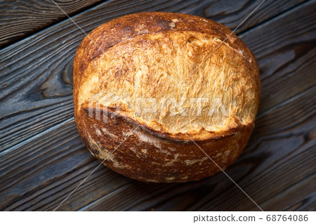 Homemade tartine bread on dark wooden table Homemade tartine bread on dark wooden table 68764086
