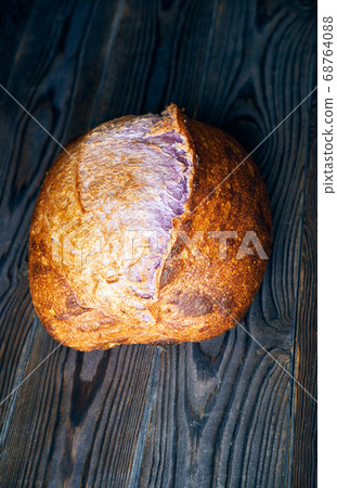 Homemade tartine bread on dark wooden table 68764088