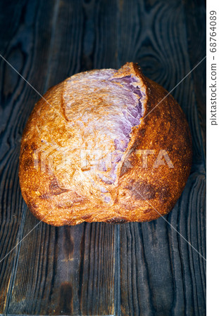 Homemade tartine bread on dark wooden table Homemade tartine bread on dark wooden table 68764089