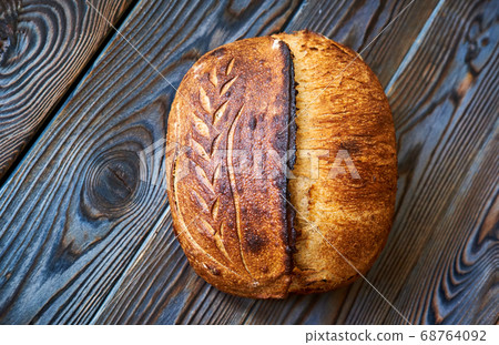 Homemade tartine bread on dark wooden table 68764092