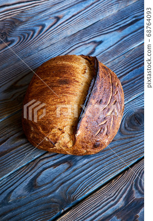 Homemade tartine bread on dark wooden table Homemade tartine bread on dark wooden table 68764093