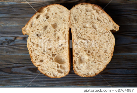 Homemade tartine bread on dark wooden table 68764097