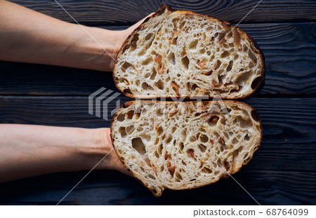 Homemade tartine bread in woman's hands 68764099