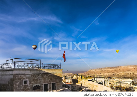 Two hot air balloons flying over Cappadicia Two hot air balloons flying over Cappadicia 68764125